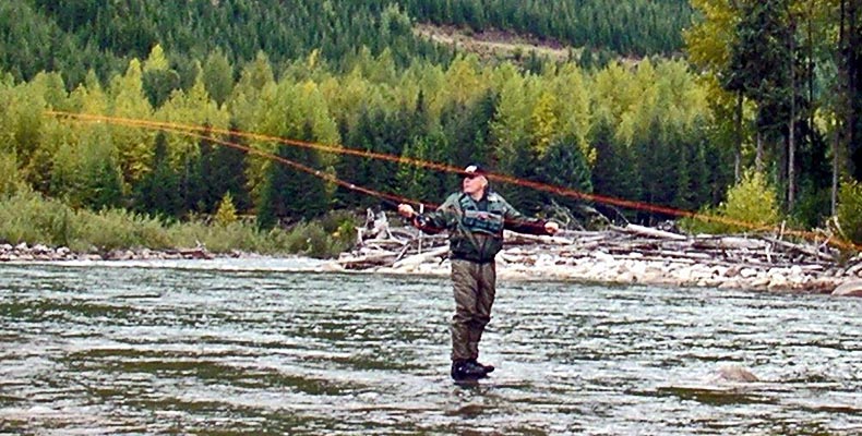 Wolfgang is casting with a fly rod on the Copper River